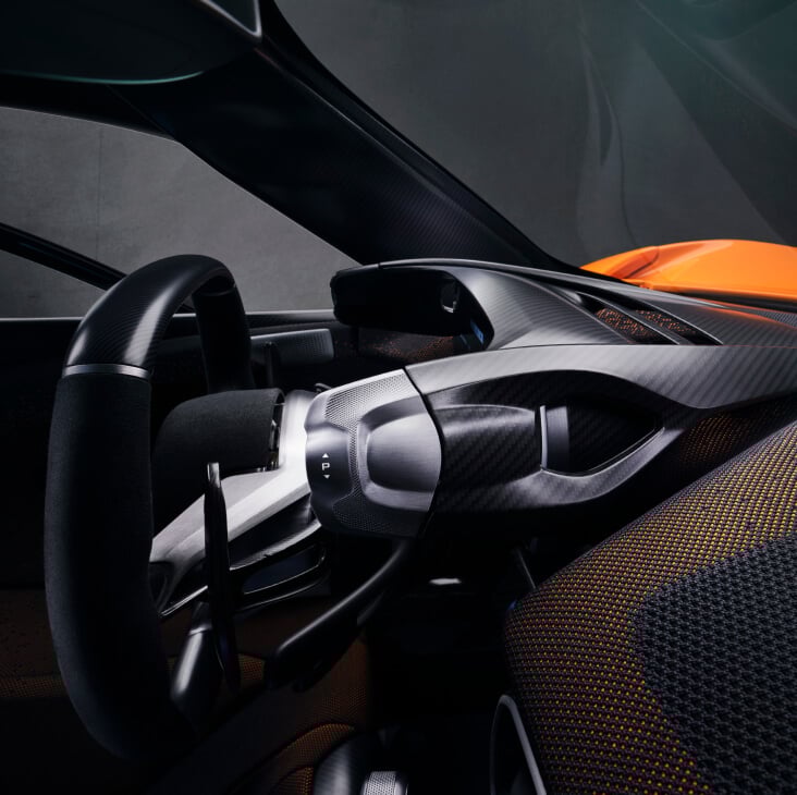 The McLaren W1 dashboard showing the steering wheel, paddles and handling switches.