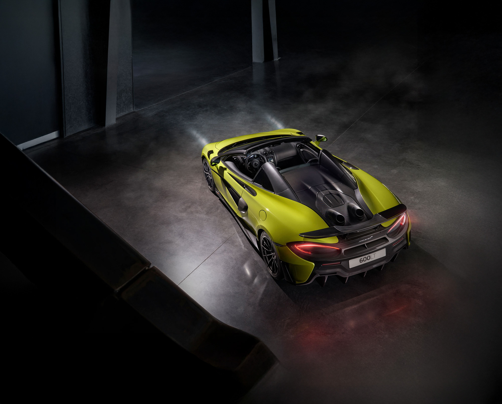 McLaren 600LT Spider in vibrant green, showcasing top-exit exhausts, carbon fiber aerodynamics, and track-focused performance