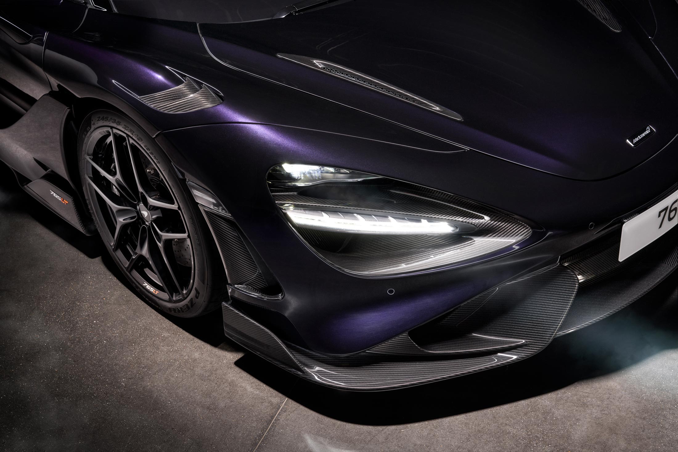 McLaren 765LT in deep purple with aggressive front splitter, and LED headlights, designed for track-focused performance