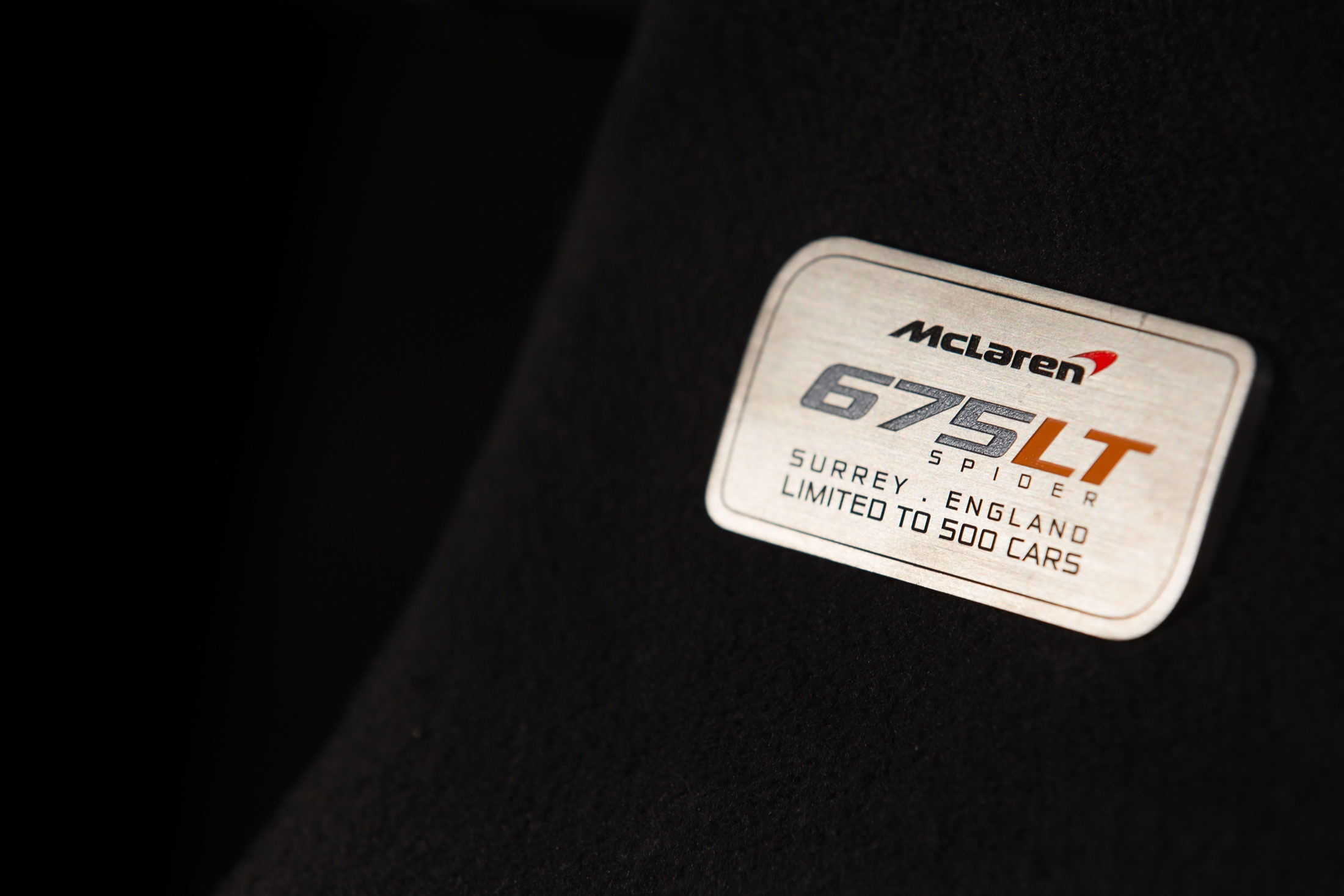 McLaren 675LT Spider nameplate, highlighting its limited production of 500 units and exclusive craftsmanship from Surrey, England