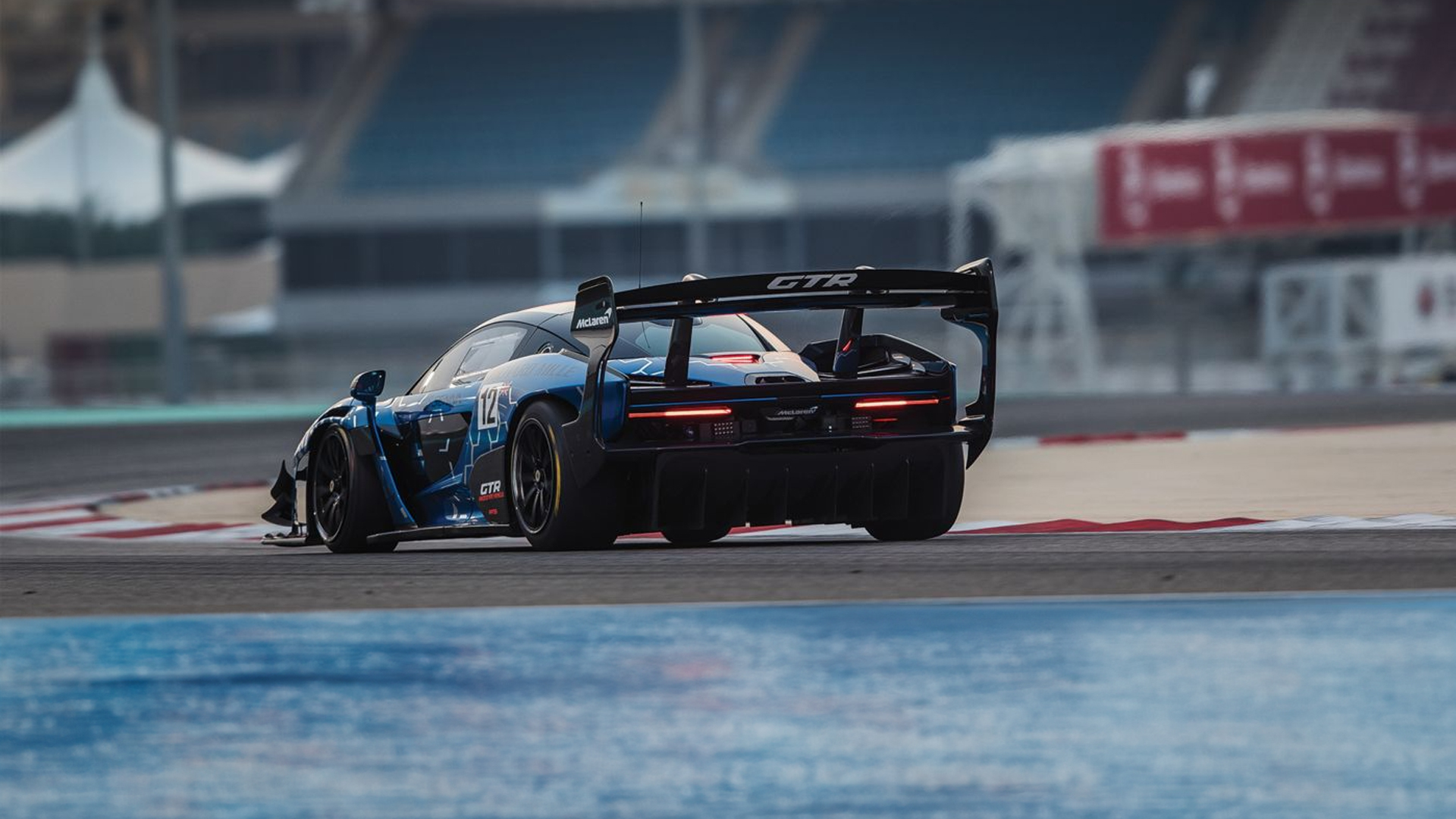 The track-only McLaren Senna GTR, a performance-focused hypercar, cornering on a circuit, highlighting its extreme aerodynamics.