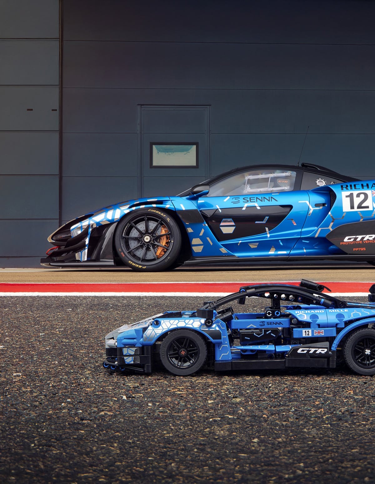 Blue McLaren parked next two a small lego version of the same car.