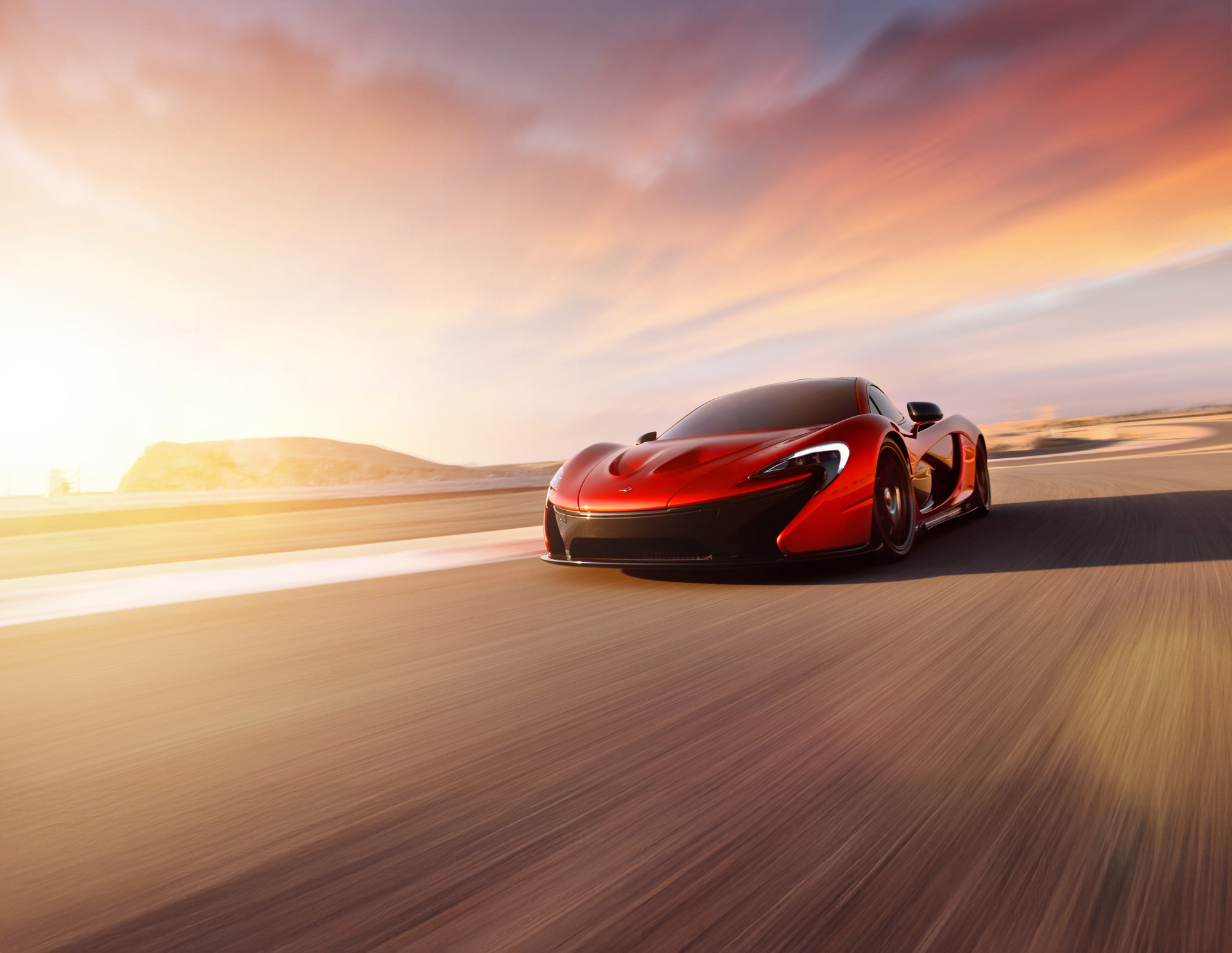 A red and black McLaren P1 supercar speeding down a road with motion blur, under a dramatic sunrise or sunset sky, with a hazy, bright horizon.