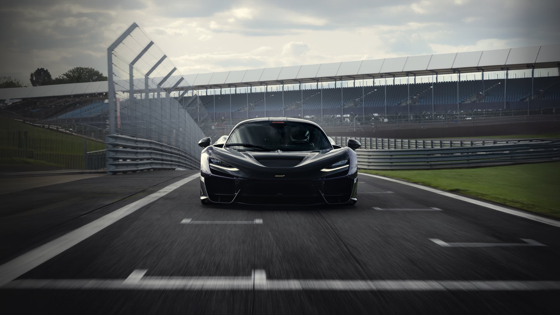 The McLaren W1 in black parked on the Silverstone track.