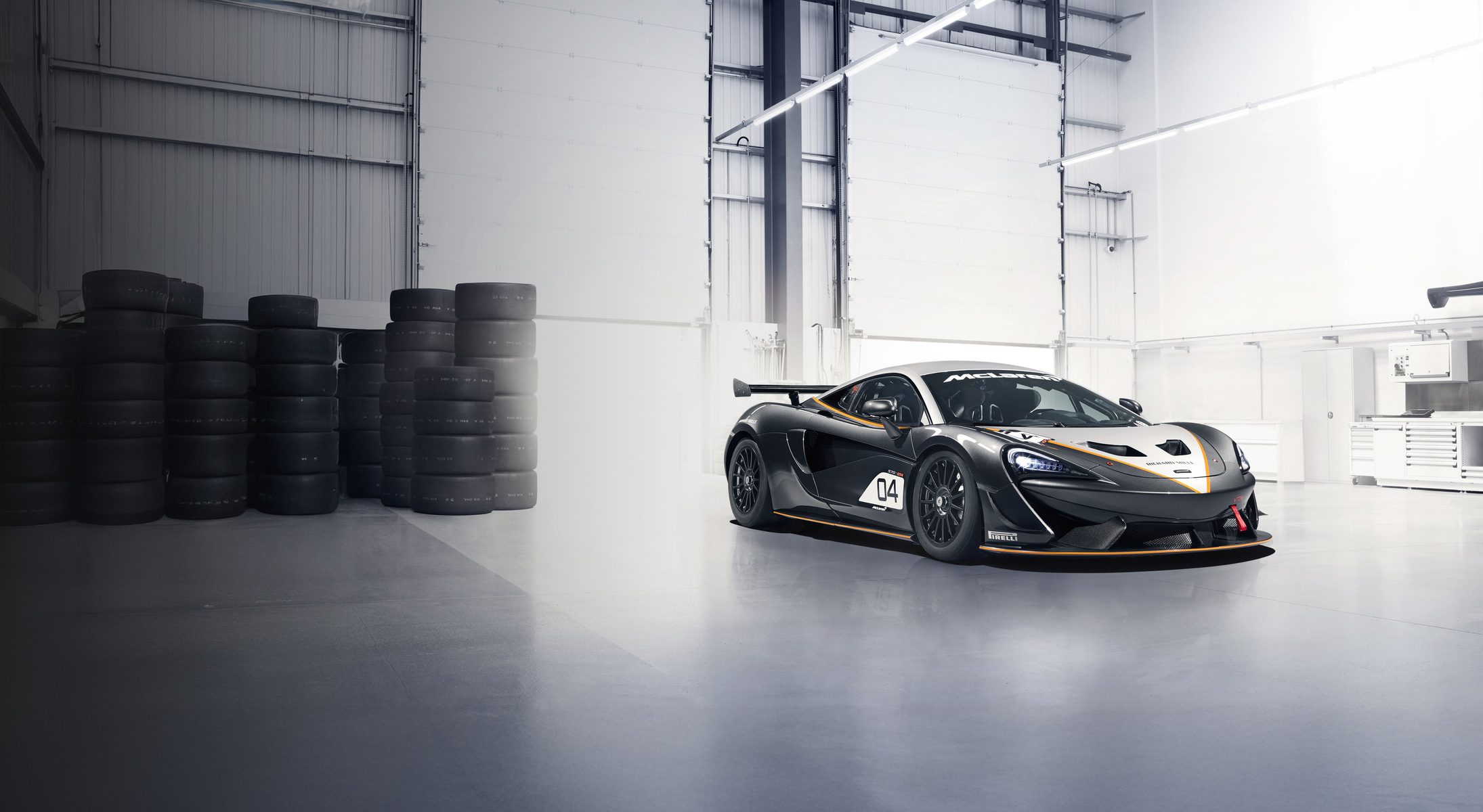The McLaren 720S GT3 EVO parked on a race track. 