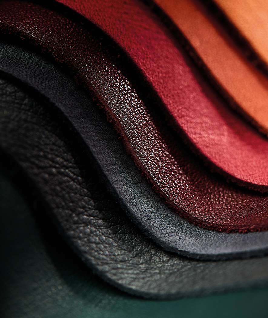 Close up shot of different McLaren leather options, layered on top of each other and fanned out in a wave.