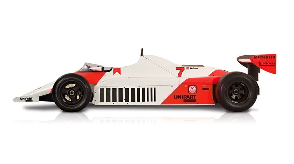 Side view of the red and white McLaren MP4/1, with the number 7 painted on the side of its body. Shown on a white background.