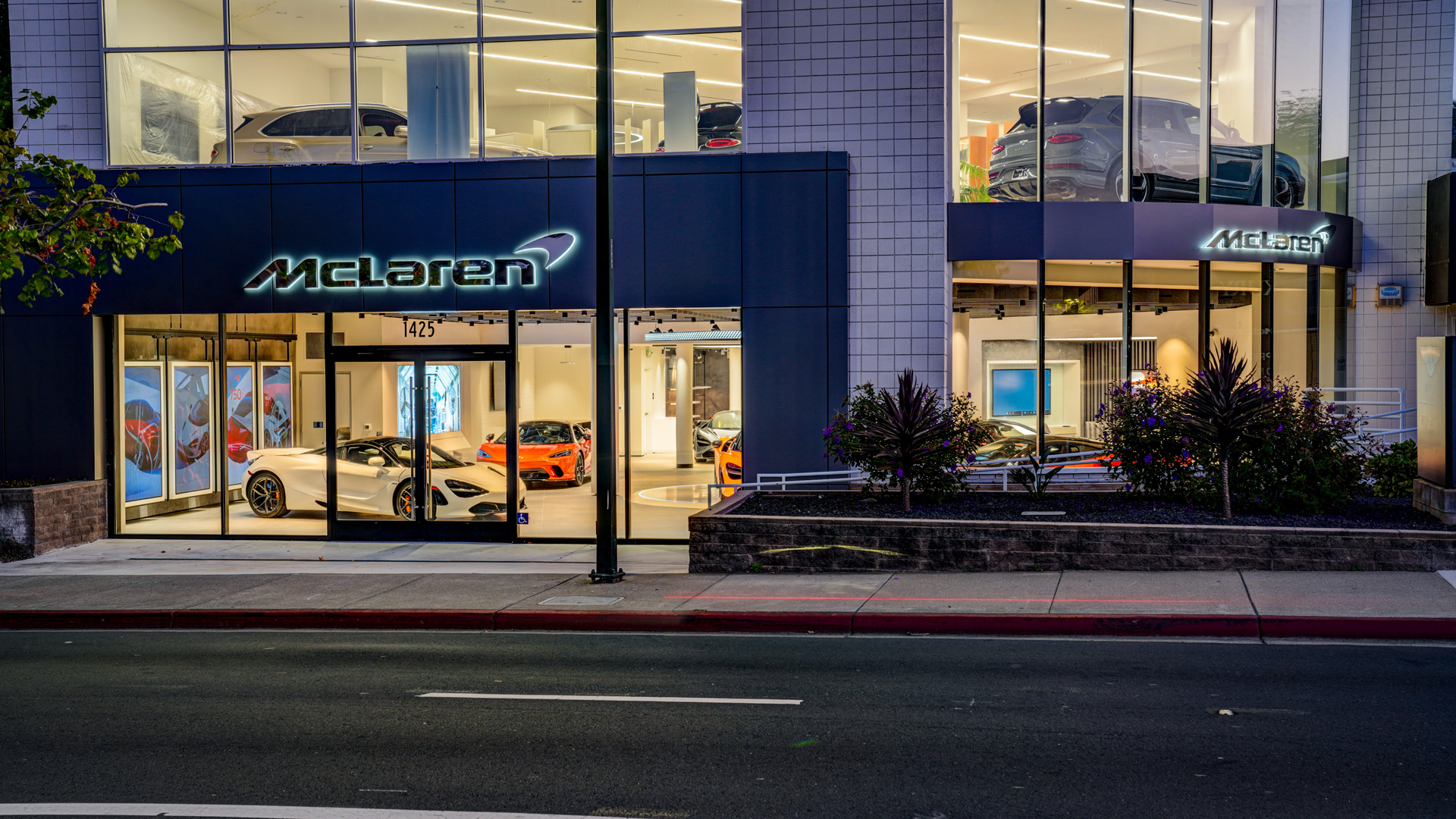 Store front of the Walnut Creek McLaren retailer, lit up inside at night