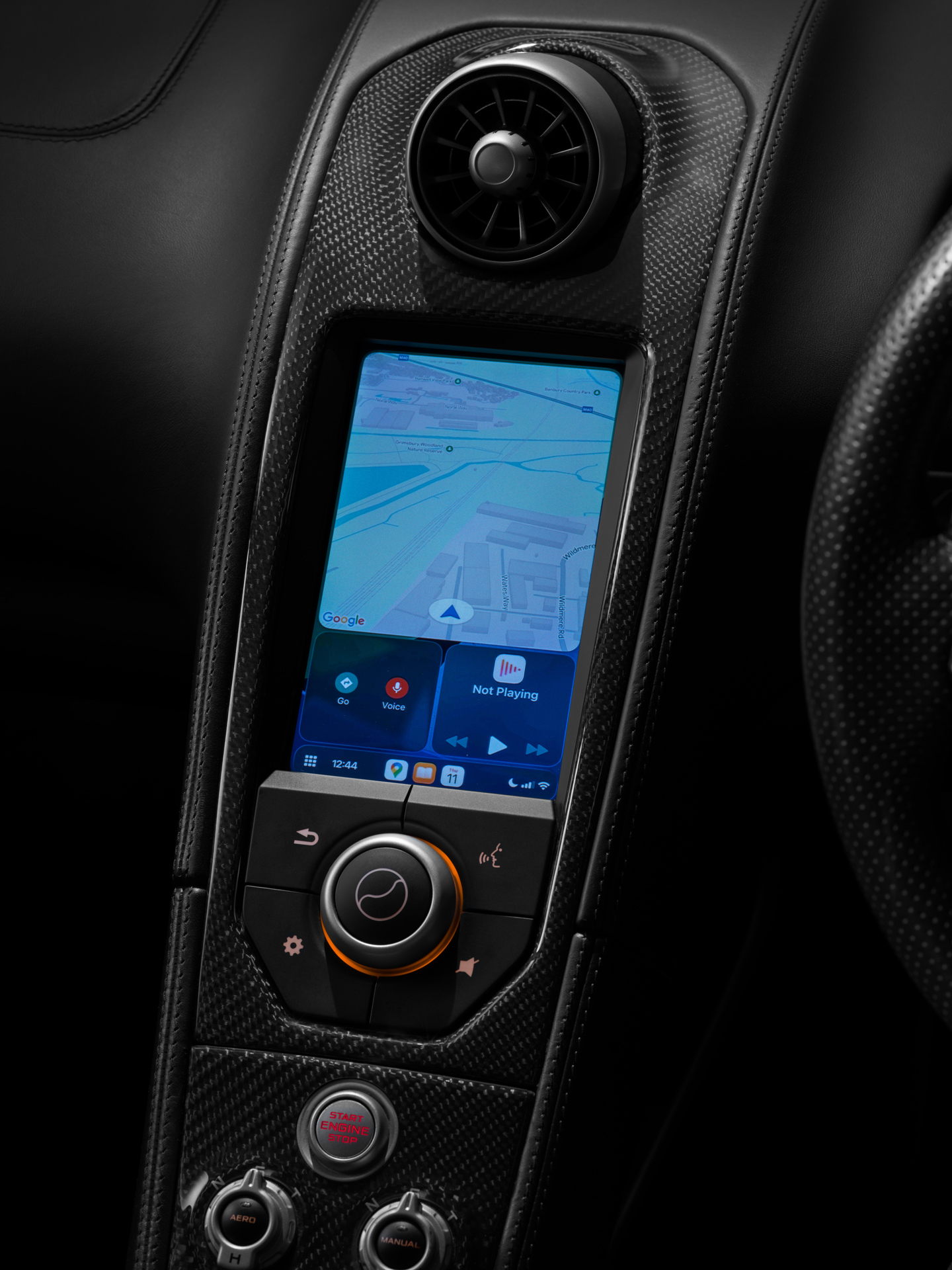 Apple CarPlay screen depicting Google Maps shown within the centre console of a McLaren Supercar