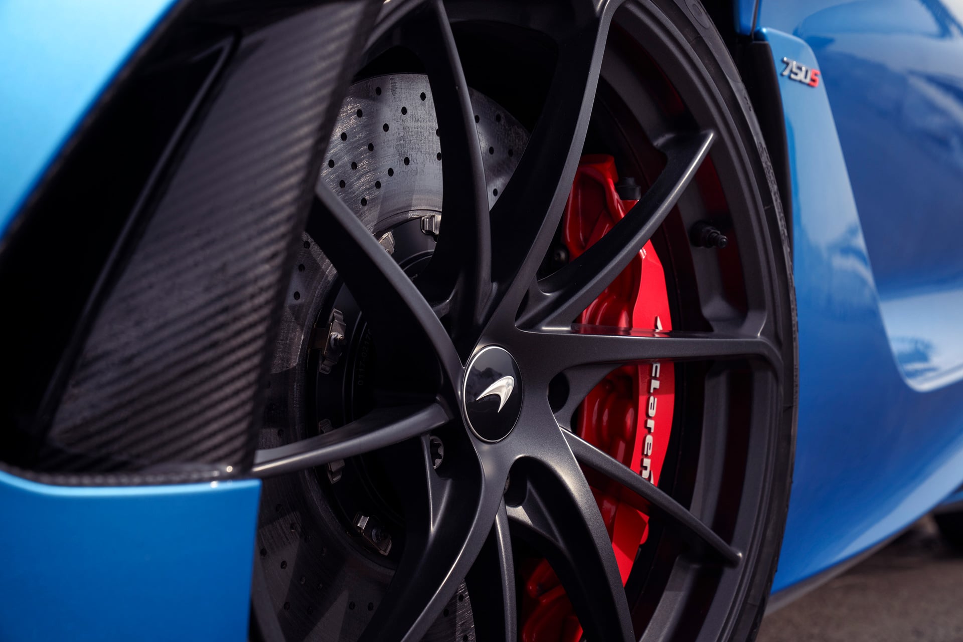 Close up of a McLaren 750S wheel with red caliper.